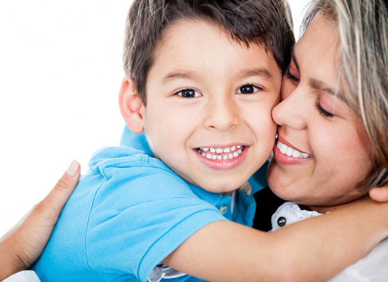 Mom and child embracing with big smiles